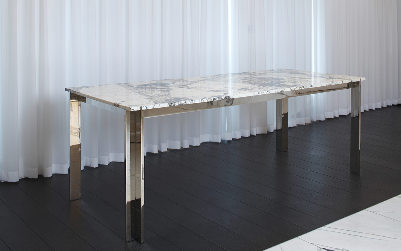 Nickel plated dining table with Patagonia Quartzite table top, photographed in the penthouse suite at the Mandrake Hotel